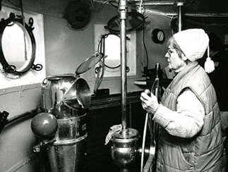 A volunteer at the helm of LV-112 while underway