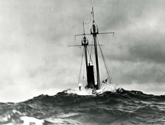 LV-112 in a storm with a wave breaking over the stern